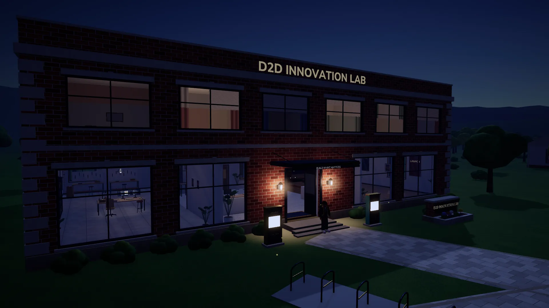 The Innovation Lab at night, its windows and entrance lamps glowing over the plaza.